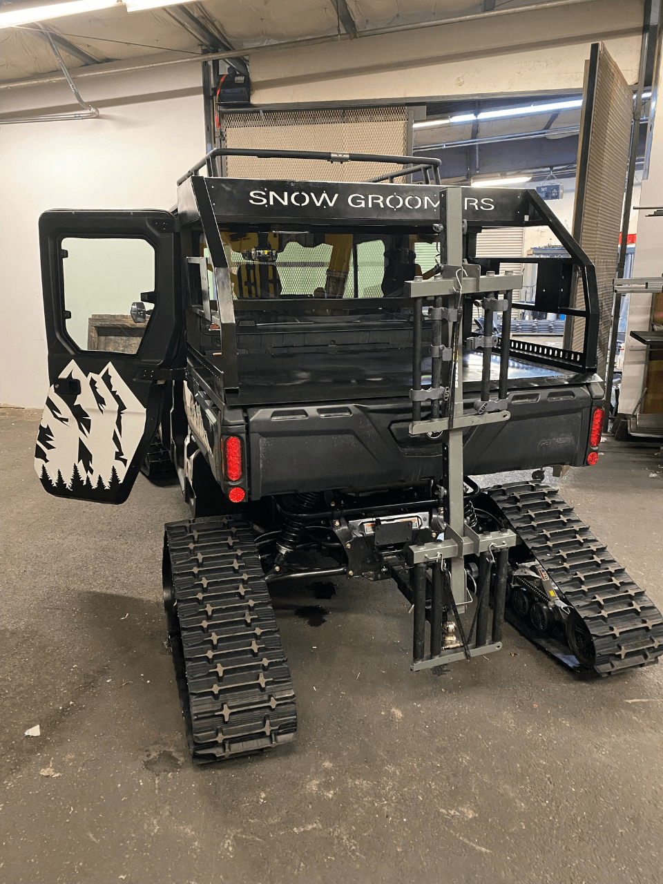 Can-Am Defender with Custom Rack at Back and Camso Tracks and Extender Hitch 18inches