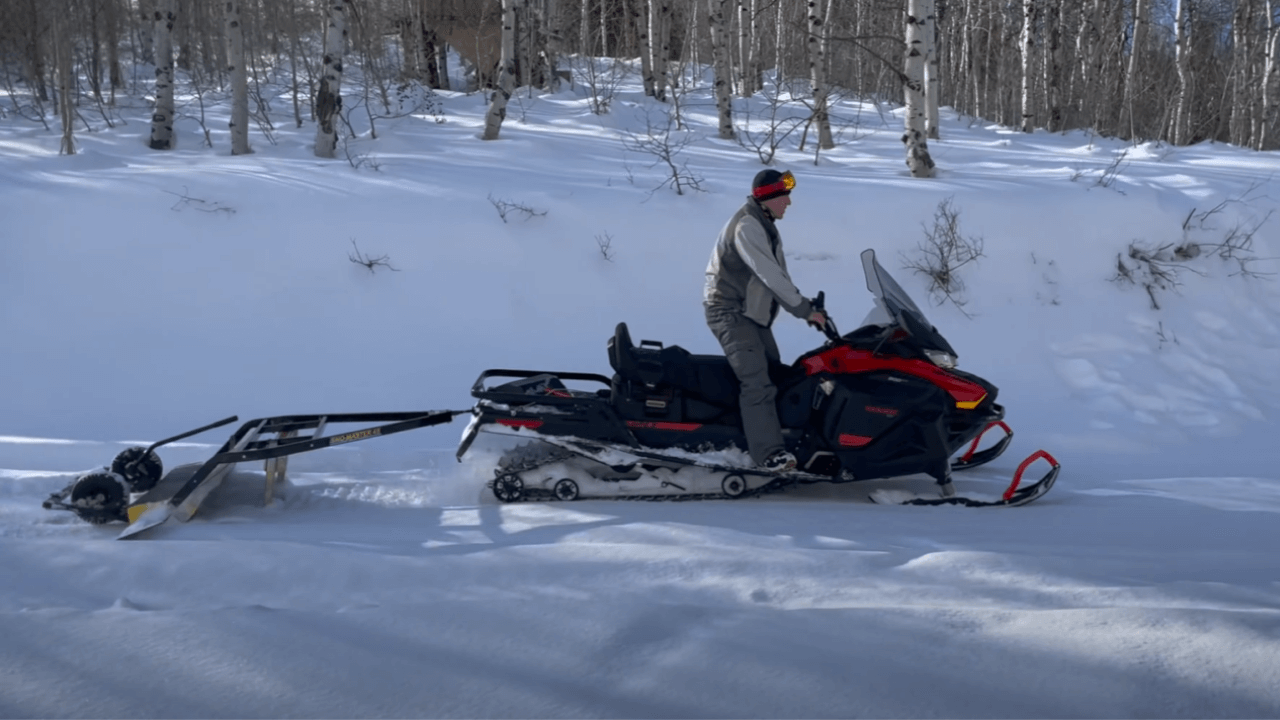 Snowmobile with a Snow Groomer
